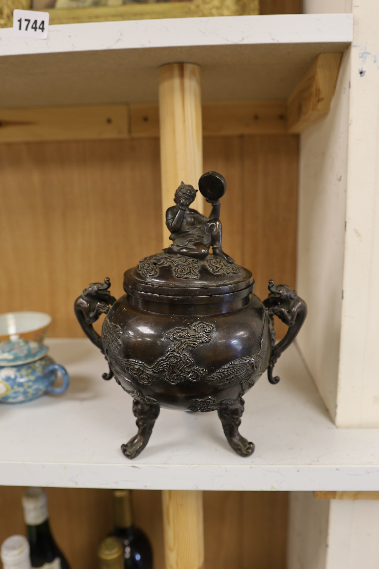 A Japanese bronze dragon handled censer with figural finial to cover, Meiji period, 24cm high. Condition - good